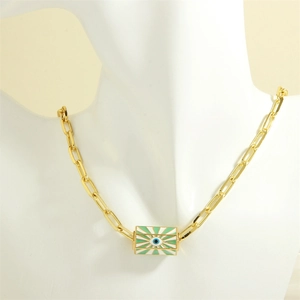 Detail of gold evil eye enamel rectangle pendant on oval link chain worn on white bust