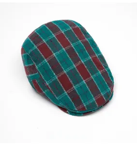 Top view of a classic plaid ivy cap featuring red and green checkered tweed fabric texture