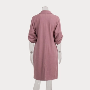 Detail of dusty pink corduroy midi dress with back slit and fine fabric texture