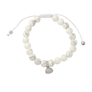 Close-up of white turquoise beaded bracelet with magnetic heart charm and woven cord