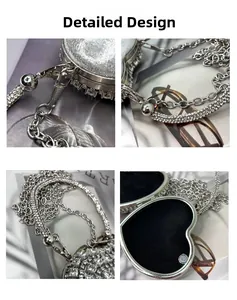 Detail design of a silver heart-shaped evening bag with sparkling rhinestones and metal chain