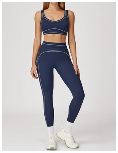 Detail view of U-neck sports bra and high-waisted leggings with white contrast stitching