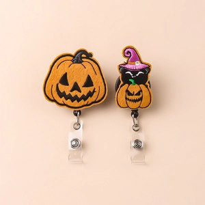 Detail of Halloween pumpkin and witch cat retractable badge reels with embroidery texture