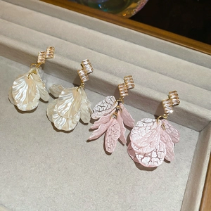 Detail of petal tassel earrings with shell luster, pink ice crack texture, and zircons