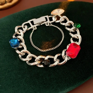 Macro view of vintage silver chain bracelet with multicolored square rhinestones