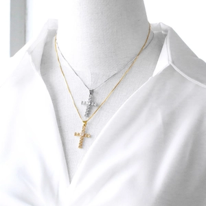 Cross pendant necklace with sparkling cubic zirconia on gold and silver thin chains