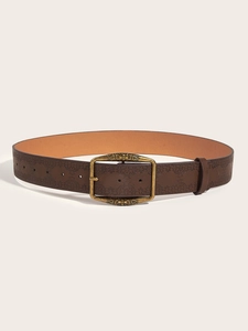 Close-up of deep brown embossed leather belt with a vintage brass buckle and totem pattern