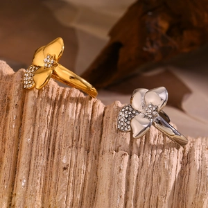 Asymmetric flower ring in 18K gold and silver plating with shimmering diamond accents