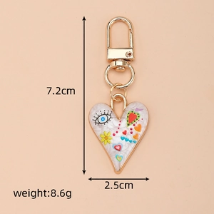 Detail shot of heart-shaped evil eye keychain with measurements 7.2cm by 2.5cm