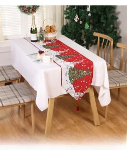 Detail of red and white Christmas table runner featuring reindeer and snowflake patterns