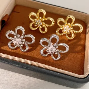 Hollow flower earrings in gold and silver with micro-pave cubic zirconia inlay