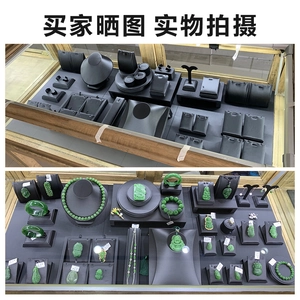 Green jade jewelry collection displayed on professional black display trays and stands