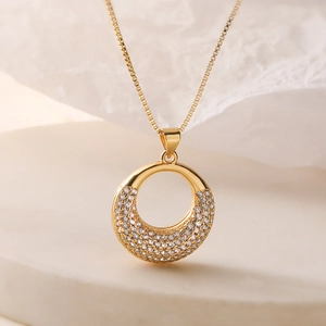 Elegant 18K gold plated necklace featuring a circular pendant with sparkling zircons
