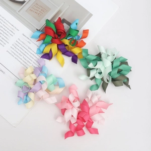 Detailed view of colorful multi-layered grosgrain ribbon spiral hair clips in various patterns