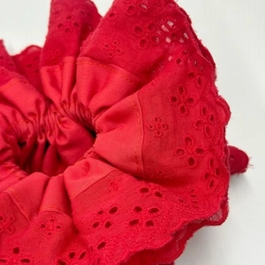 Close-up of red lace embroidery texture on a high-elastic pleated scrunchie fabric