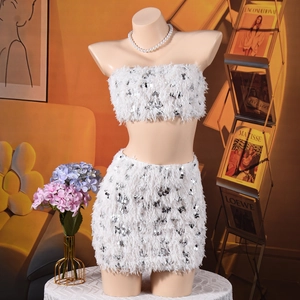 Detail of white sequined crop top and mini skirt set with textured fringe trim