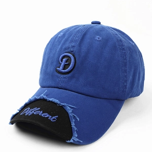 Detail of navy blue cotton baseball cap featuring frayed edges and custom 3D letter embroidery
