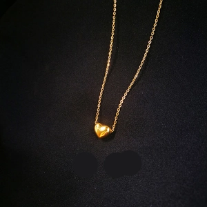 3D heart pendant necklace in 18K gold plated stainless steel on a dark background