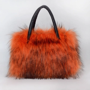 Detail of the high-end faux fur tote bag with orange and black textures and leather handles