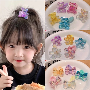 Detail of colorful resin flower and bear hair clips with vibrant candy colors for girls