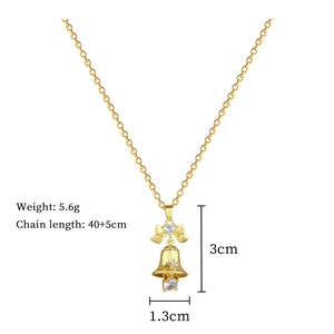 Detailed view of bow and bell pendant with size specs 3cm x 1.3cm on gold chain