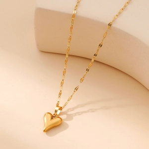 Elegant gold heart pendant necklace with twisted flat chain on a minimalist background
