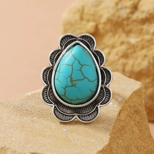 Vintage bohemian turquoise ring in silver teardrop setting on a natural desert rock