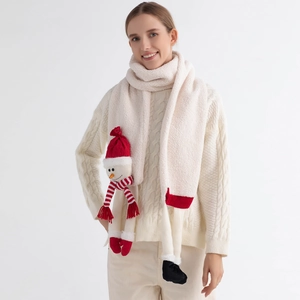 Close-up of soft plush Christmas scarf featuring a cute snowman doll with red accents