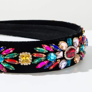 Close-up of colorful crystals and rhinestones on high-quality black velvet headband