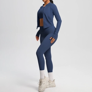Detail of dark blue three-piece yoga set featuring a slim-fit zip jacket and leggings