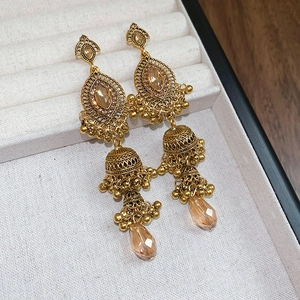 Detail of vintage flower Jhumka earrings with champagne rhinestones and teardrop charms