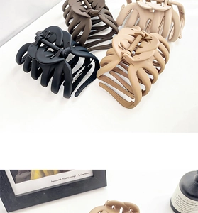 Set of four matte octopus hair claws in black, brown, beige, and khaki colors