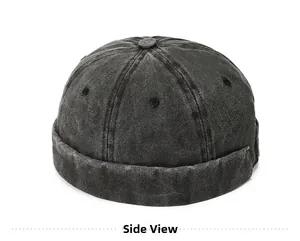Side view detail of washed black denim docker cap showing vintage texture and stitching