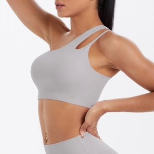 Detail of light grey one-shoulder sports bra featuring cut-out strap and brushed fabric