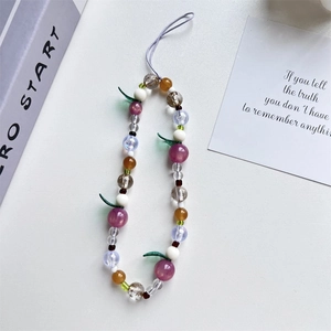 Pink tulip and purple berry beaded phone strap with green leaves on white background