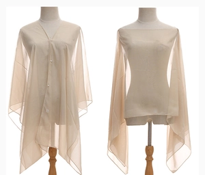 Detail of beige sheer chiffon shawl showing button closure and versatile scarf styling