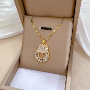 Elegant gold heart ring pendant necklace with sparkling cubic zirconia in a jewelry box