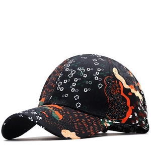 Detail of multi-color abstract floral pattern and stitching on a black baseball cap