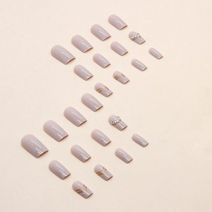 Elegant mauve square press-on nails with golden chevron lines and silver rhinestones