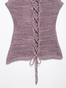 Detail shot of purple knitted top featuring an elegant lace-up back design