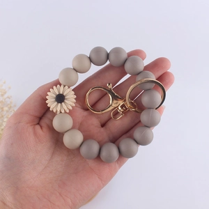 Silicone daisy beaded bracelet keychain with grey and beige beads and golden lobster clasp