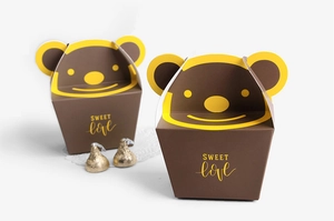 Detail view of cartoon bear paper gift boxes with gold foil sweet lettering