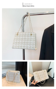 Detail of white plaid tweed crossbody bag featuring elegant gold chain strap and texture