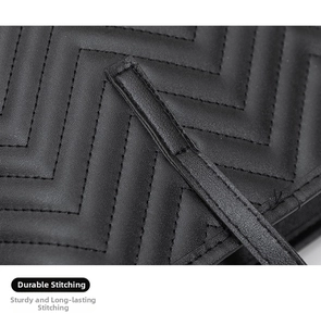Close-up of black quilted leather tote showing precise V-shaped stitching and texture