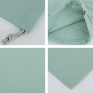 Detail view of light green canvas drawstring bag with woven rope and neat stitching