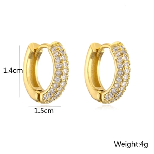 Detail view of gold huggie earrings with dimensions 1.4cm height and 1.5cm width