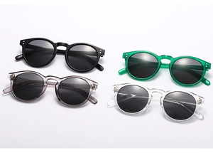 Flat lay of retro rectangle sunglasses in black, green, grey, and clear colors
