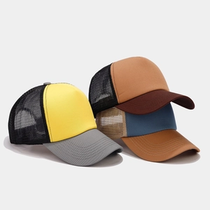 Three minimalist mesh trucker hats in yellow, brown, and blue with curved visors
