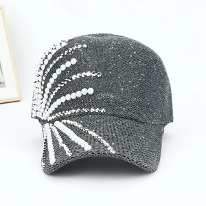 Detail of dark grey sun hat with white pearls and silver cone rhinestones decoration