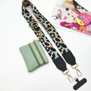 Detail of adjustable leopard print wide strap and mint green dual zipper crossbody pouch